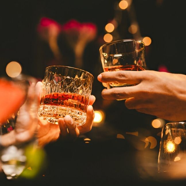 cheers toast with whisky glasses