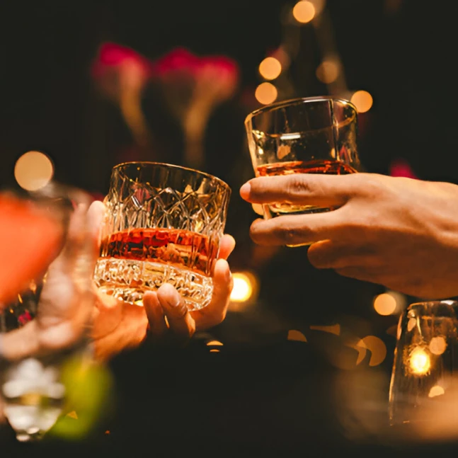 cheers toast with whisky glasses