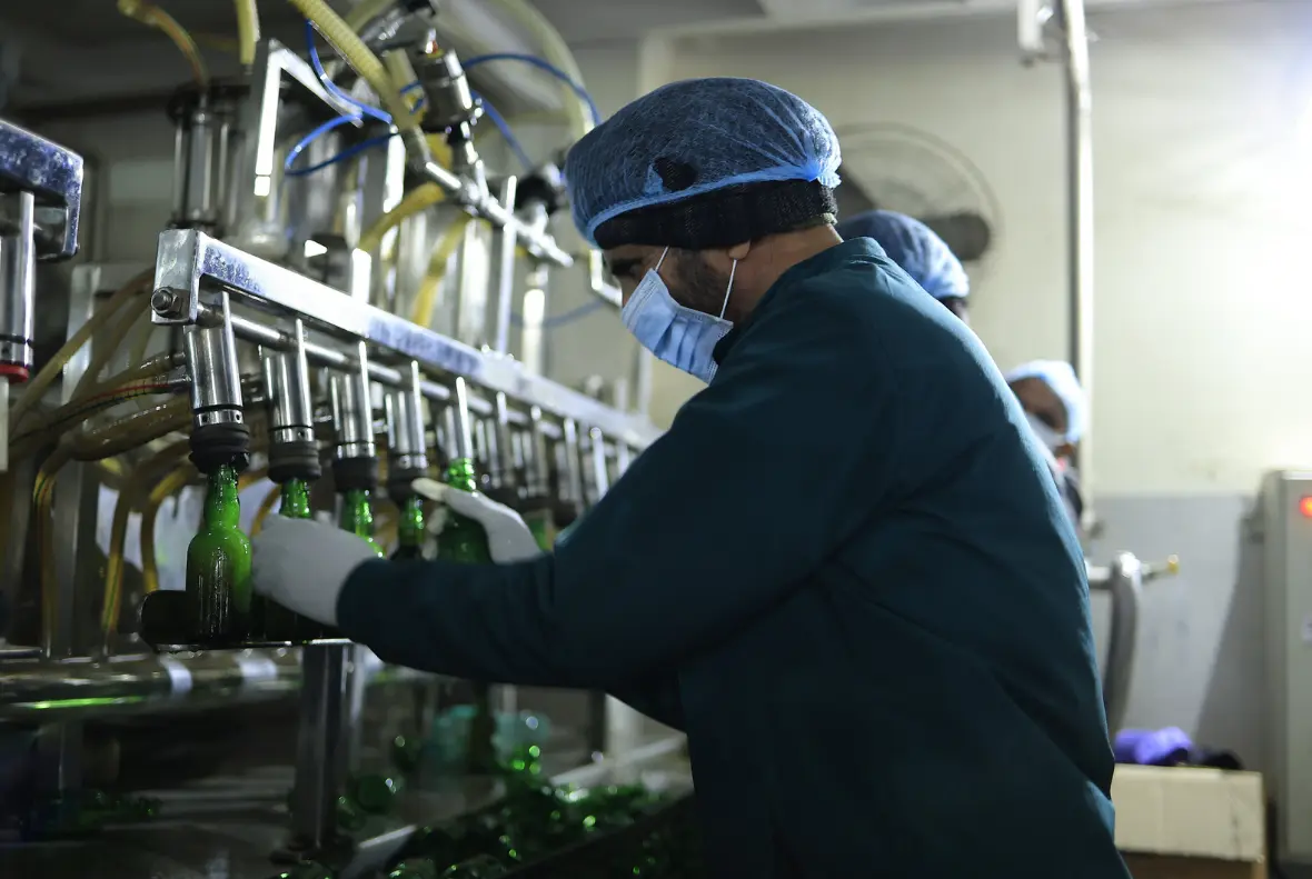Workers carrying out production activities at Sarao Distillery